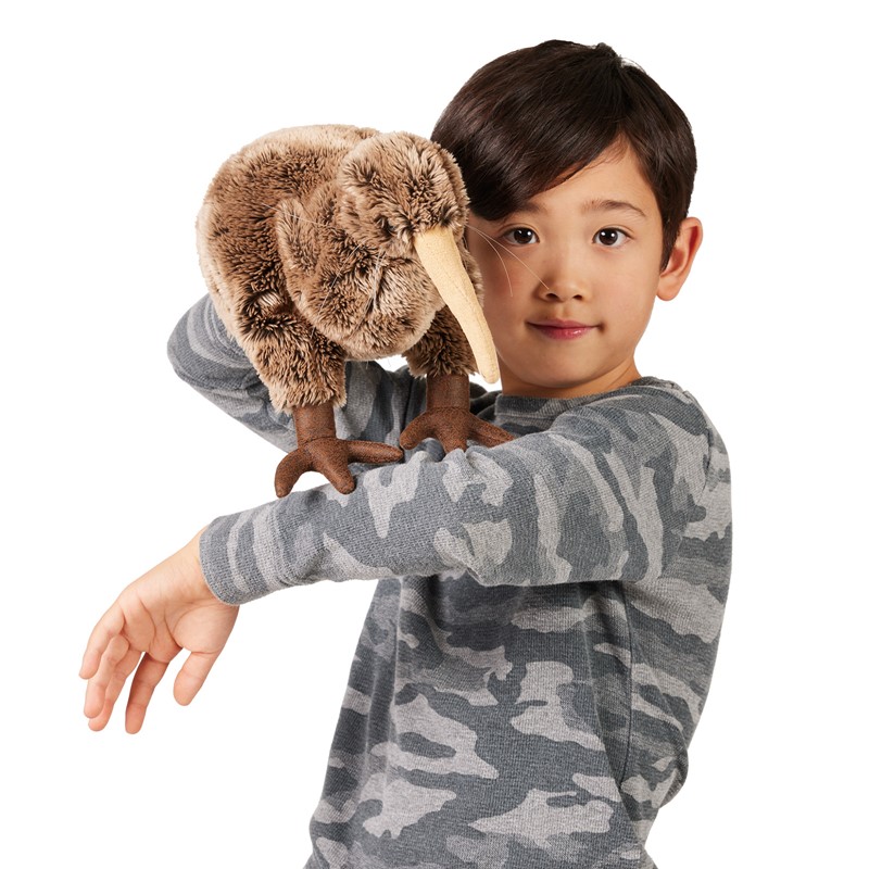 Folkmanis kiwi hand puppet on a boy's outstretched arm, brown plush feathers and long beige beak, front view