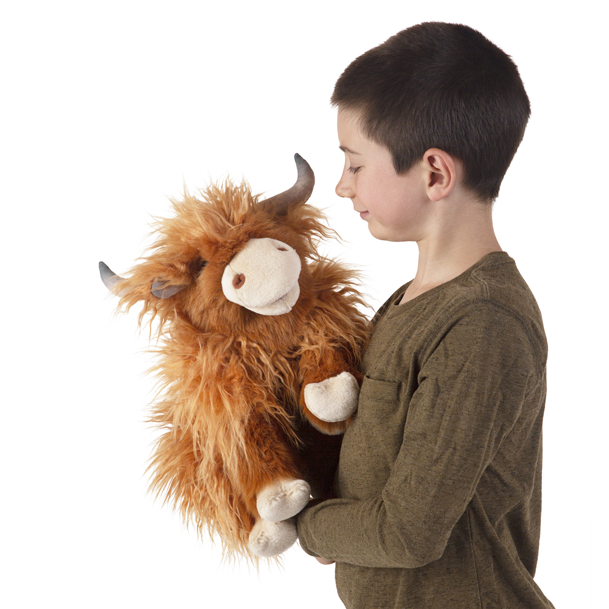 Boy holding a Folkmanis Scottish Highland cow hand puppet with shaggy reddish-brown fur and curved horns, side view