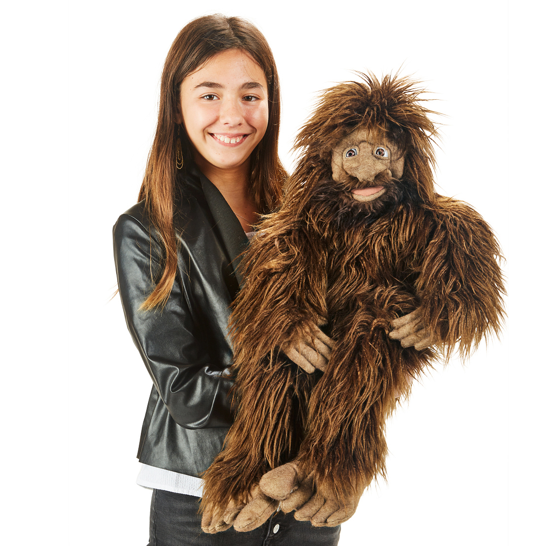 Girl holding a large Folkmanis Bigfoot hand puppet with shaggy dark brown fur and an expressive face