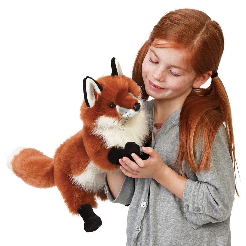 Girl holding the Folkmanis large red fox hand puppet with red fur, white chest and black paws