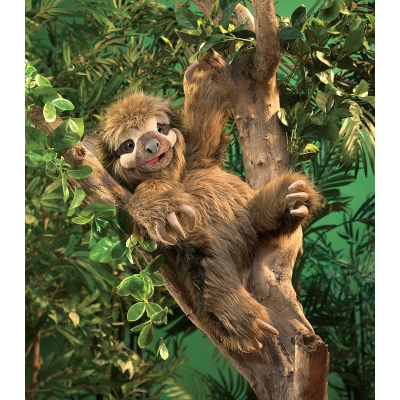 Folkmanis three-toed sloth hand puppet with brown plush fur and characteristic claws clinging to a branch in a jungle setting