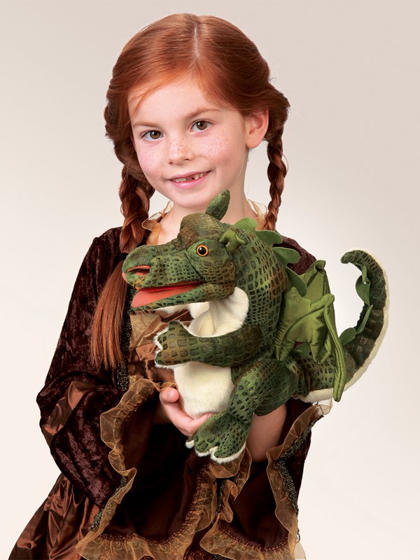 Girl holding a green Folkmanis baby dragon hand puppet with a movable mouth and wings