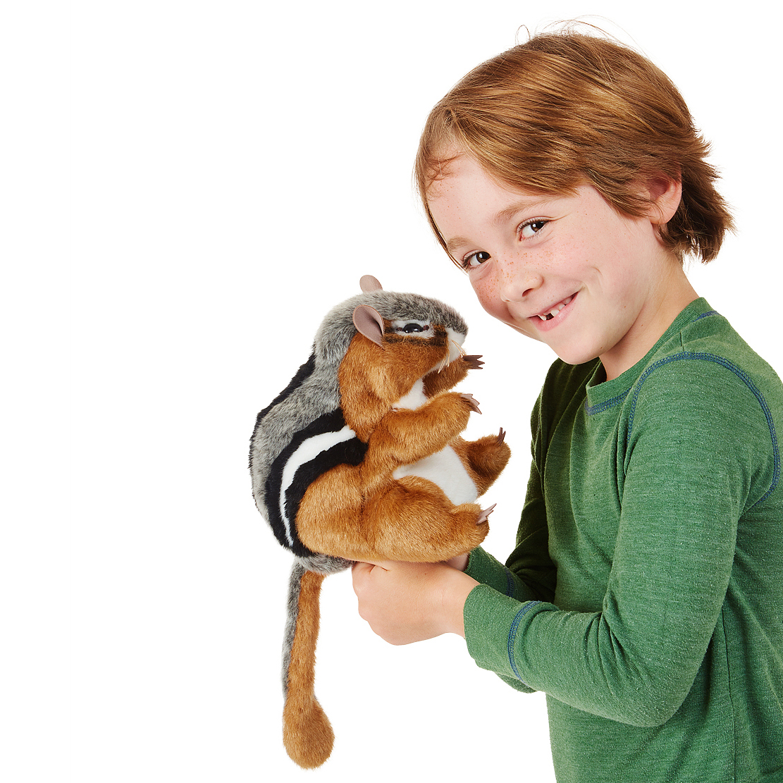 Boy holding a Folkmanis chipmunk hand puppet with brown, grey and black striped fur and a movable mouth