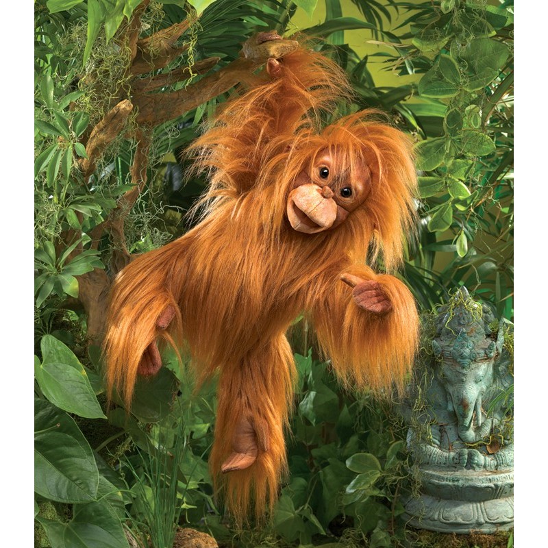 Folkmanis hand puppet baby orangutan with red shaggy fur, open mouth and outstretched arm against a green jungle background