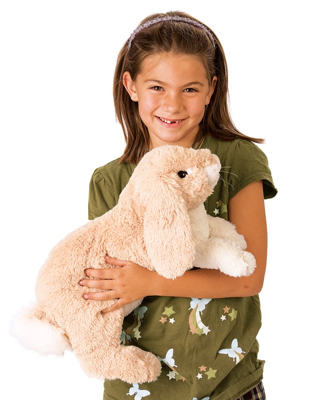 Girl holding the Folkmanis floppy bunny hand puppet in cream plush with long floppy ears in her arms