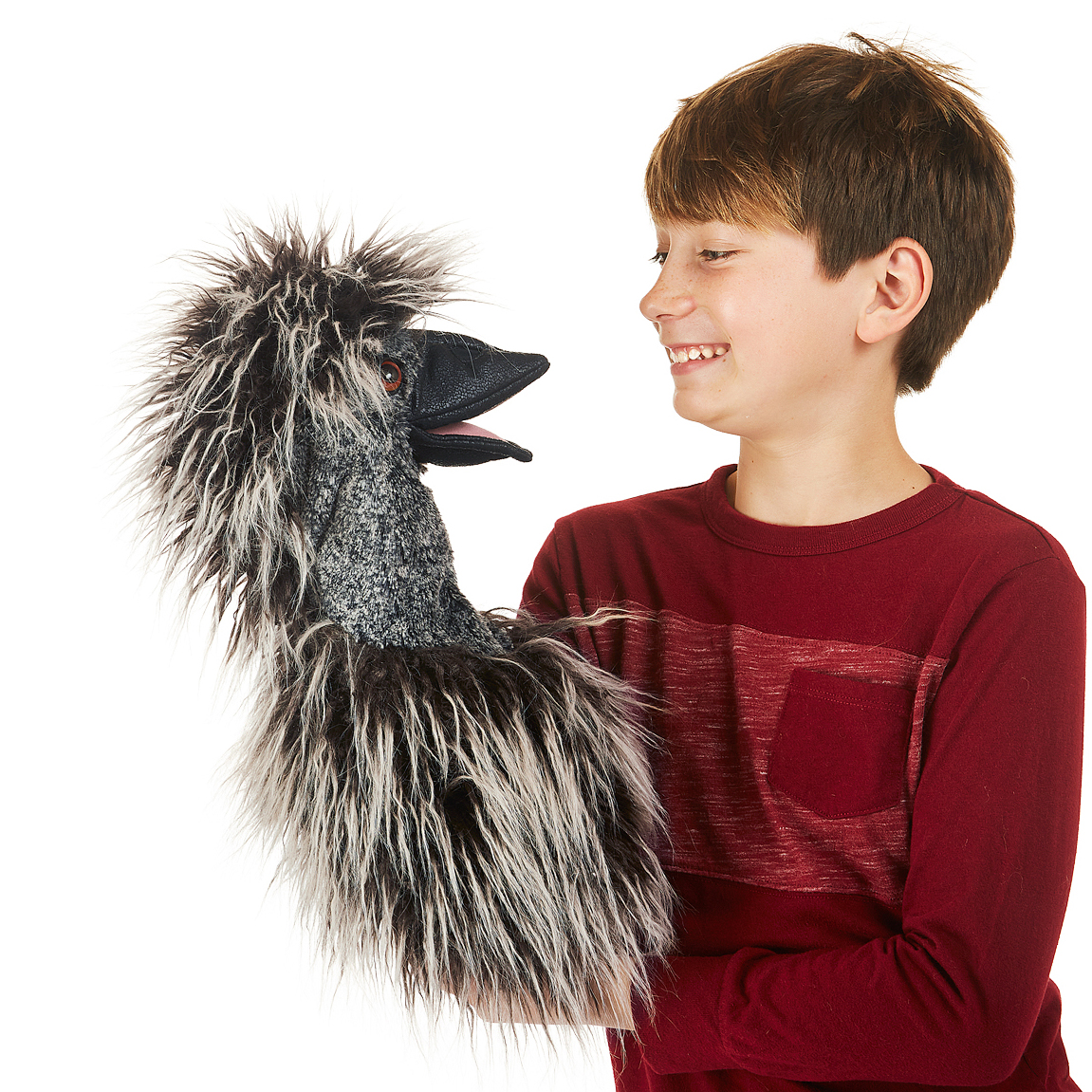 Boy holding a Folkmanis emu hand puppet with ruffled grey-black plumage and a movable beak toward the camera