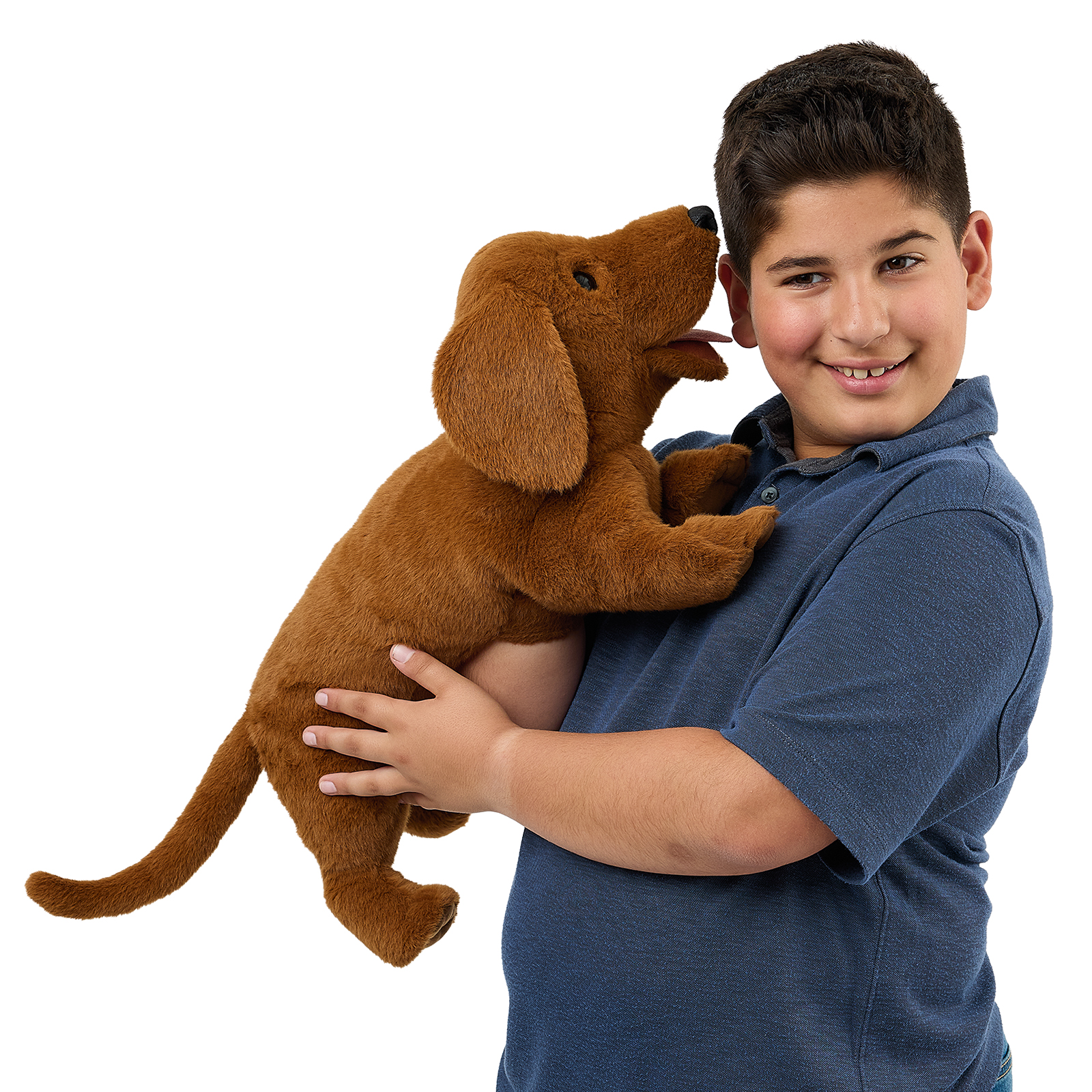 Folkmanis dachshund hand puppet on a boy's arm, its head close to his cheek with the mouth open.