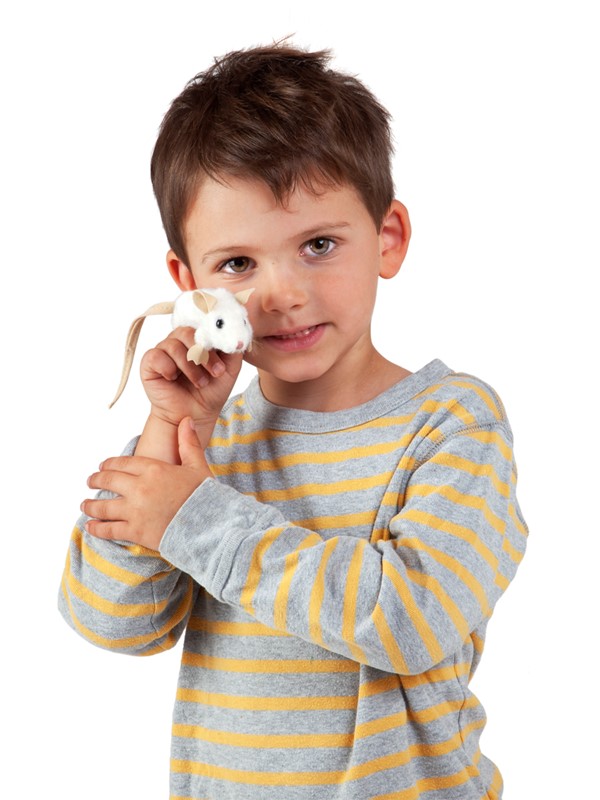Child holding a Folkmanis mini white mouse finger puppet on their finger and smiling at the camera