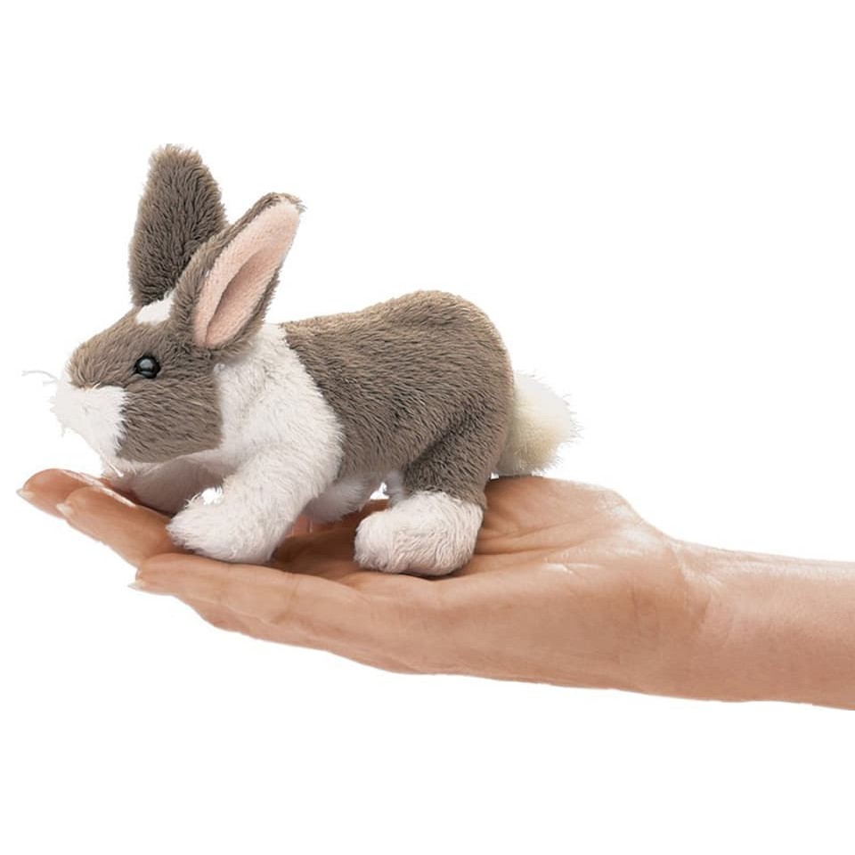 Folkmanis mini rabbit finger puppet in grey and white lying on an open palm, side view
