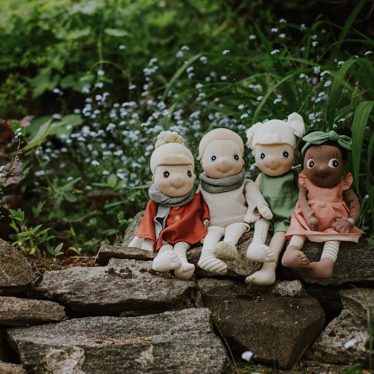 The four Rubens EcoBuds dolls in seasonal outfits on the garden wall, winter in beige