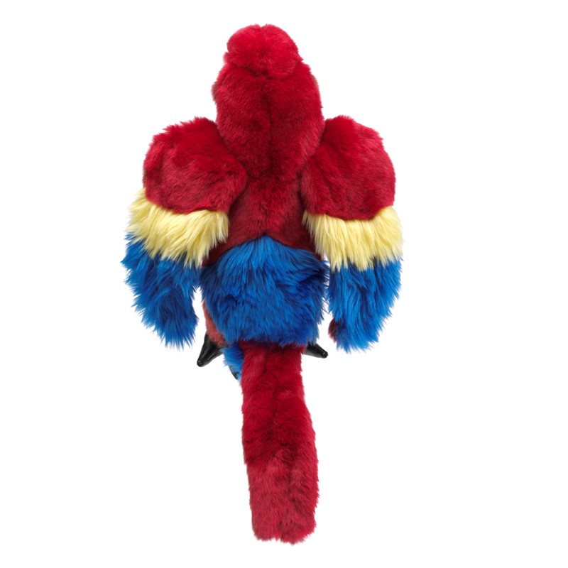 Folkmanis scarlet macaw hand puppet seen from above, with vibrant red plush feathers, yellow-and-blue wings, and a long red tail