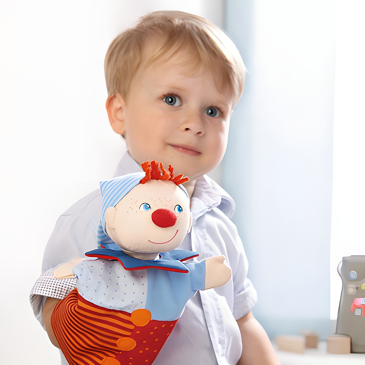 HABA baby hand puppet Kasper, lifestyle photo of a boy wearing the puppet