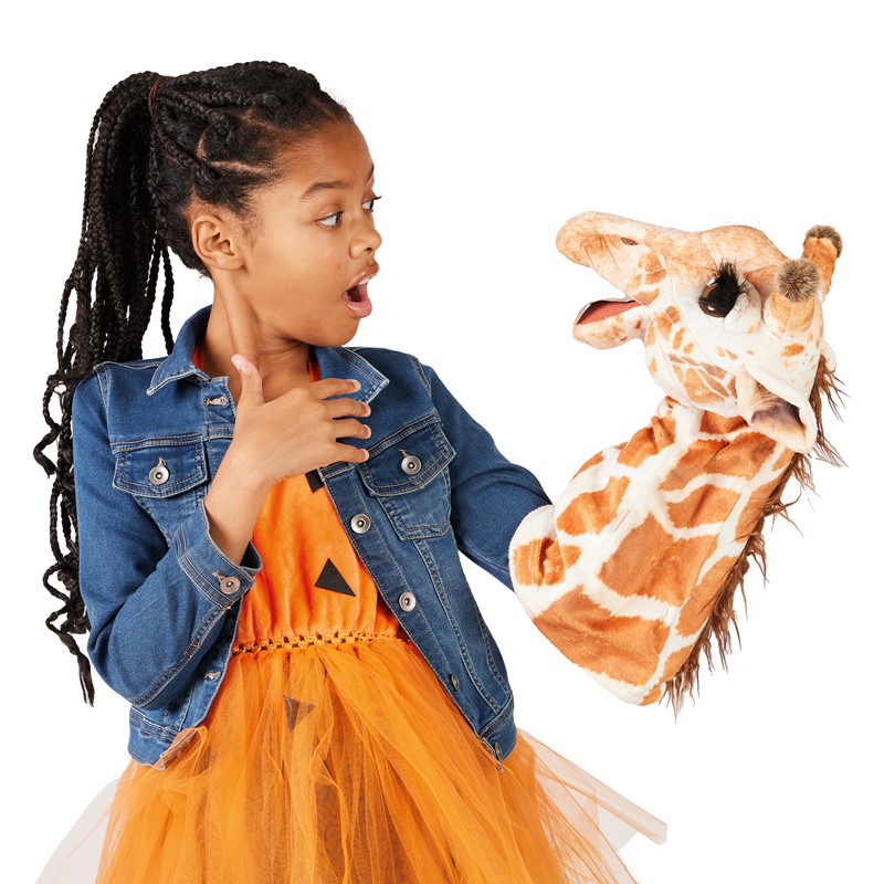 Girl holding a Folkmanis giraffe hand puppet with a movable mouth up in the air, looking at it with her mouth wide open