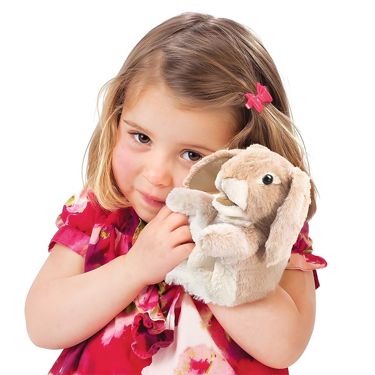 Girl holding a Folkmanis hand puppet little lop-eared rabbit in beige plush with long floppy ears against her cheek