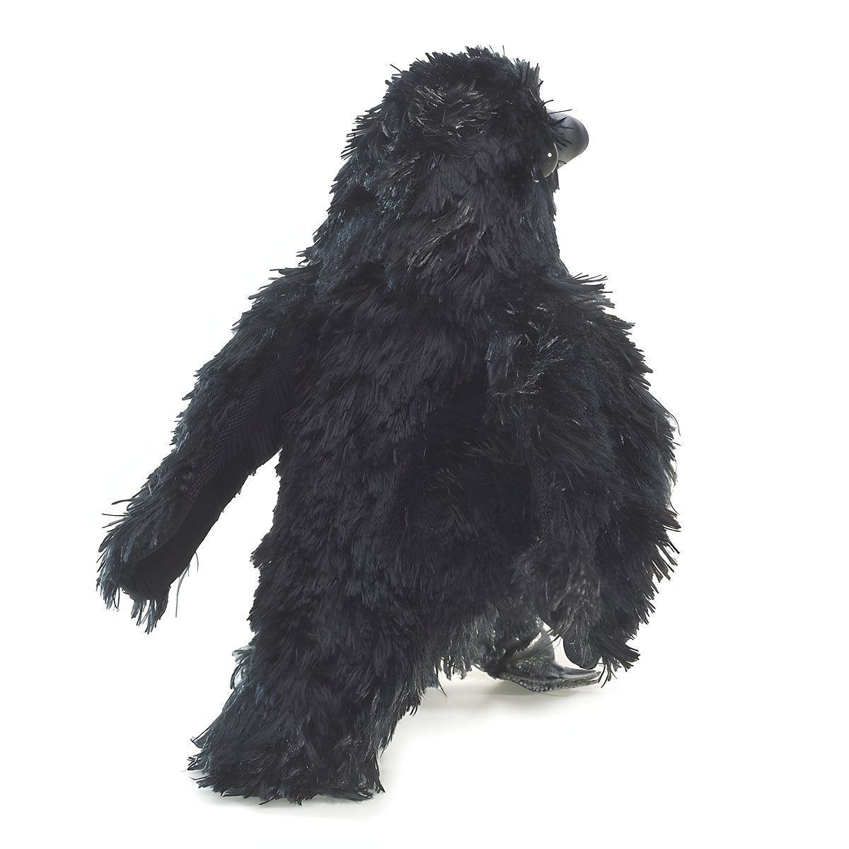 Folkmanis mini raven finger puppet made of black shaggy plush in an upright pose, shown from a side angle