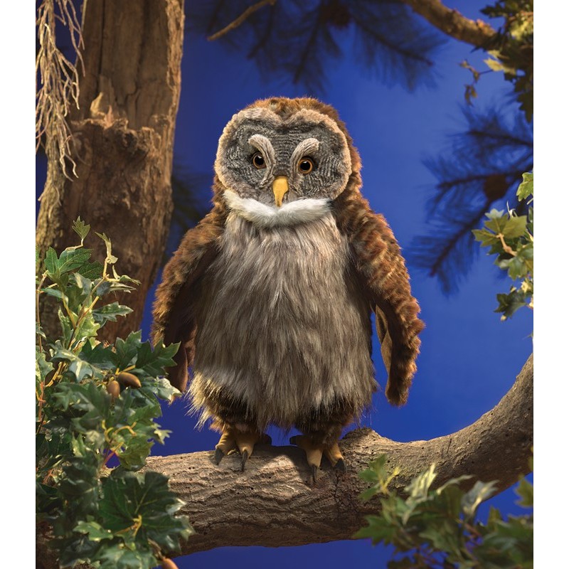 Folkmanis hand puppet owl with brown-grey plush plumage and a yellow beak, sitting frontally on a branch