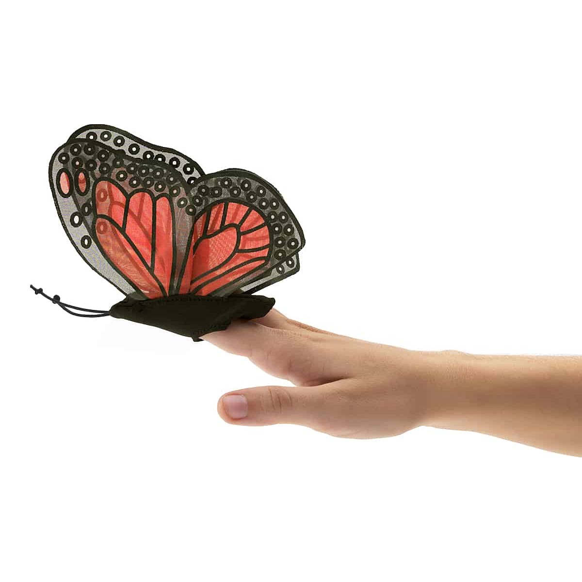 Folkmanis mini monarch butterfly finger puppet with red and black wings on an index finger, side view