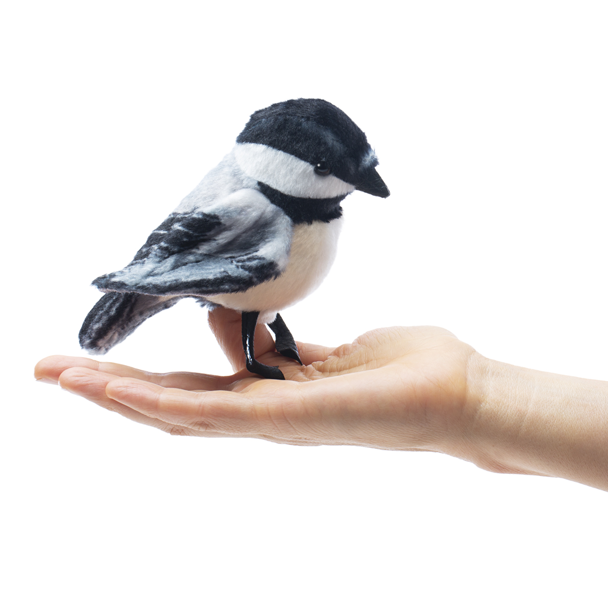 Folkmanis finger puppet mini chickadee in black and white sitting on an open palm, side view