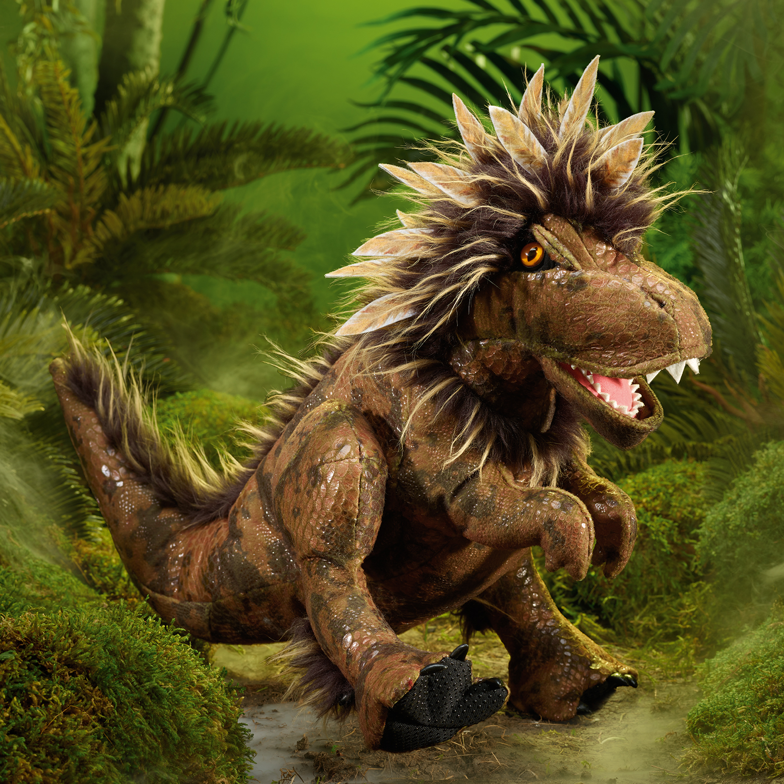 Folkmanis feathered Tyrannosaurus Rex hand puppet standing in a jungle setting, its mouth open to show the teeth.