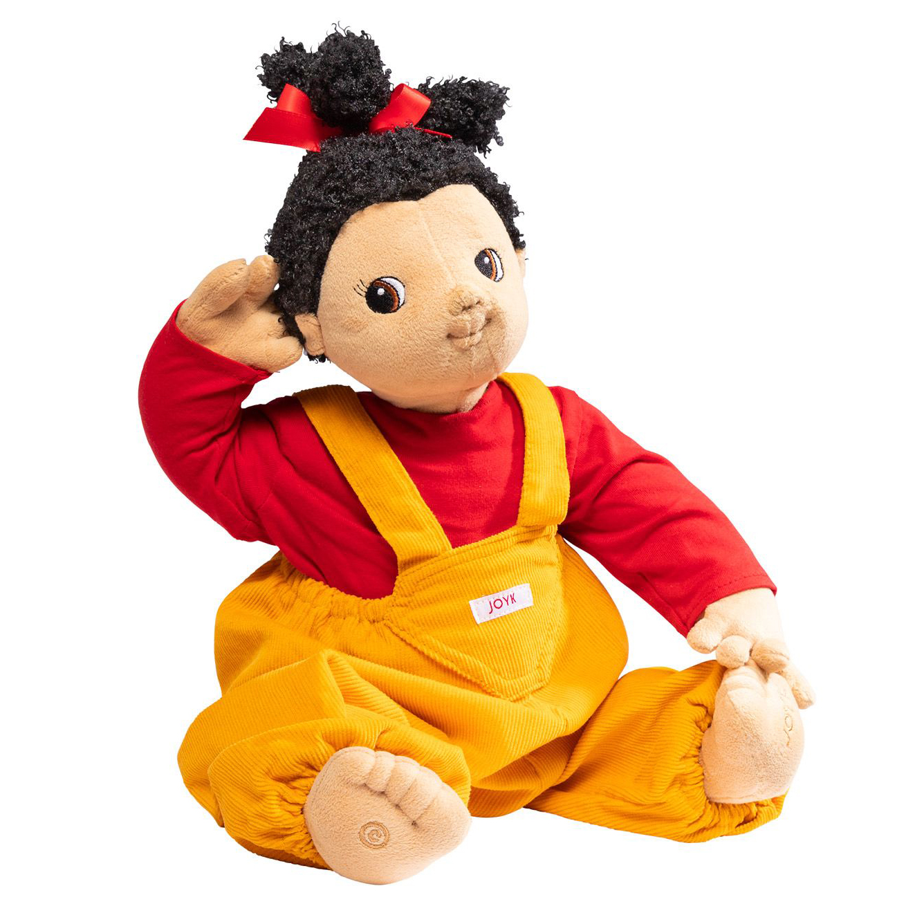Joyk empathy doll Naomi with dark pigtails, red shirt and yellow corduroy dungarees, sitting
