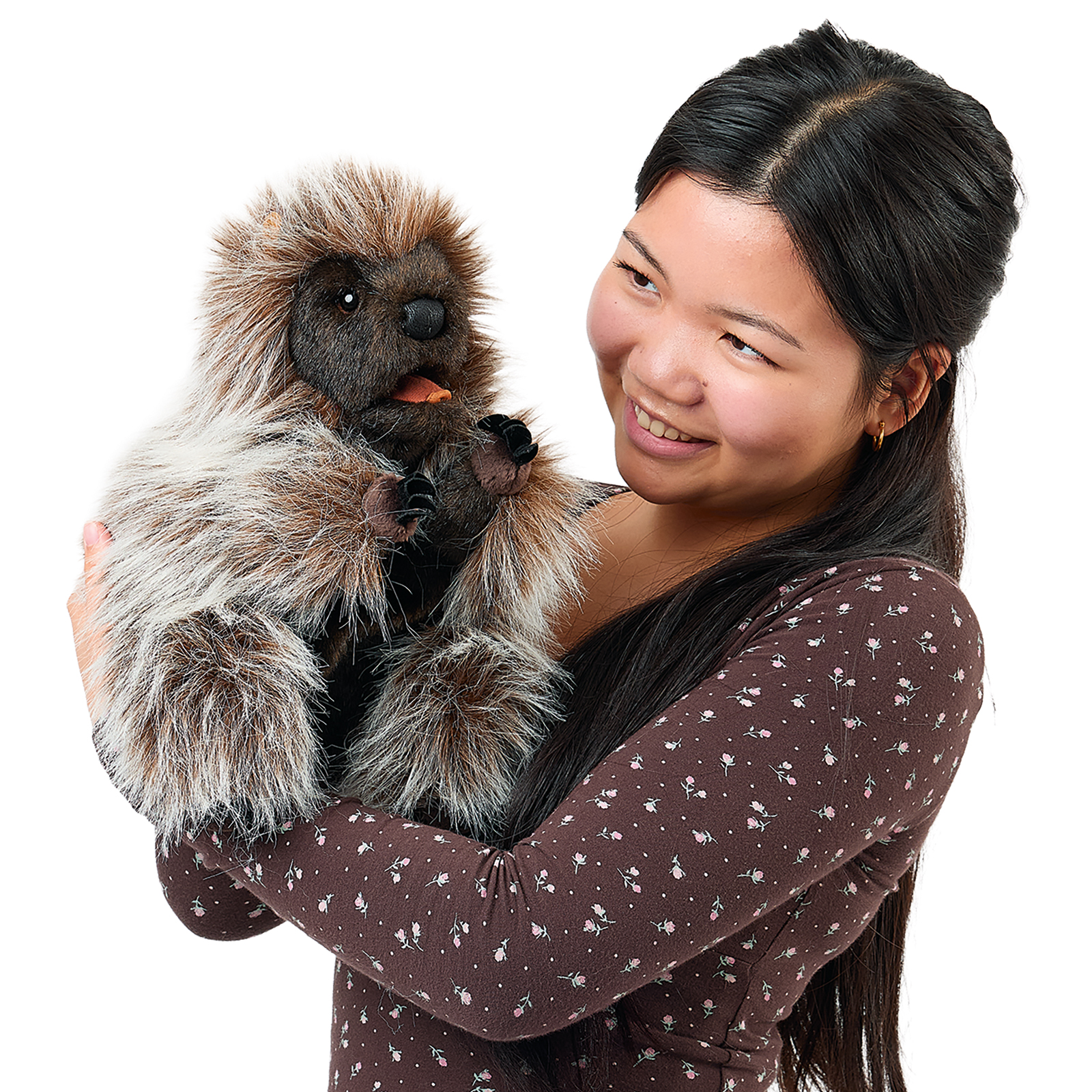 Folkmanis standing porcupine hand puppet on a young woman's arm, its mouth open with the tongue visible.