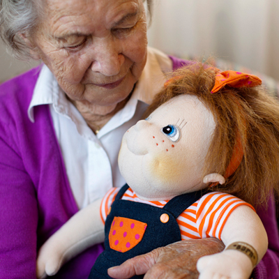 Senior lady holding the Rubens Barn Original doll Anna in her arms