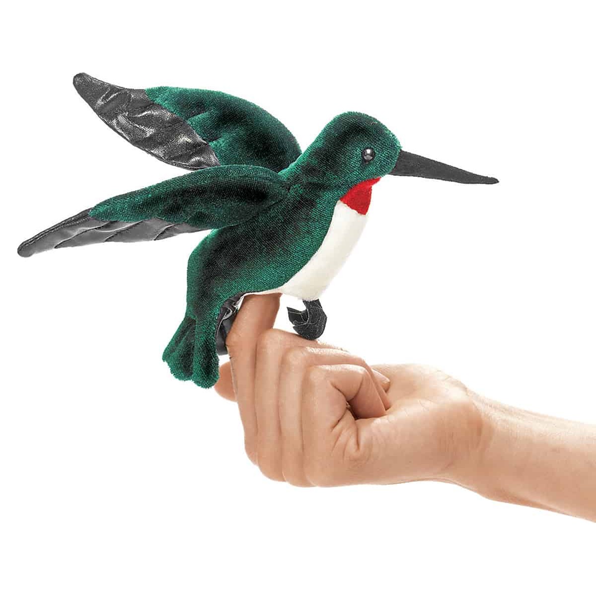 Folkmanis mini hummingbird finger puppet in green with a red throat and black wings, worn on an index finger, side view