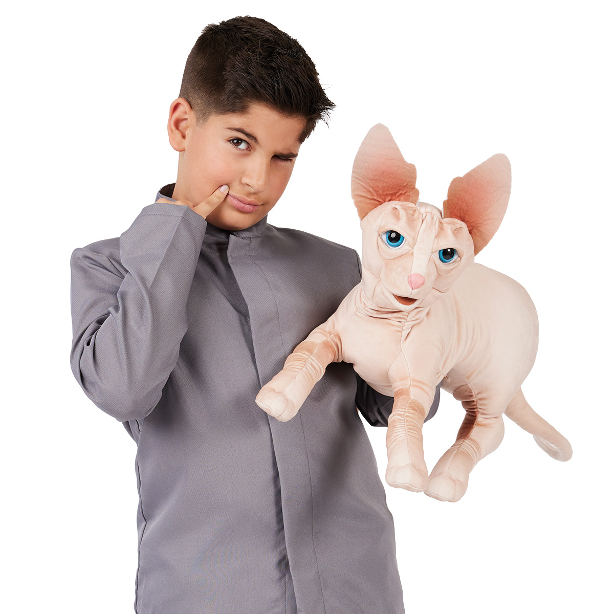 Boy holding a Folkmanis Sphynx cat hand puppet with blue eyes and large ears in beige velvet fabric sideways to the camera