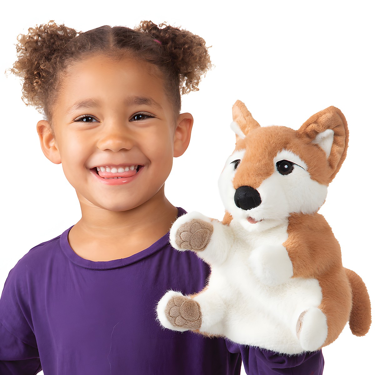 Girl holding a Folkmanis Shiba Inu hand puppet with brown-and-white fur and detailed paws up to the camera