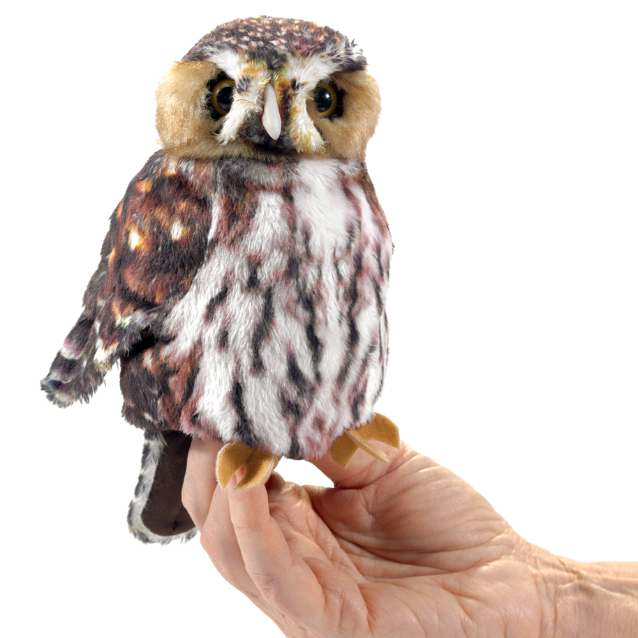 Folkmanis saw-whet owl finger puppet with brown and white spotted plumage, sitting on a hand, front view