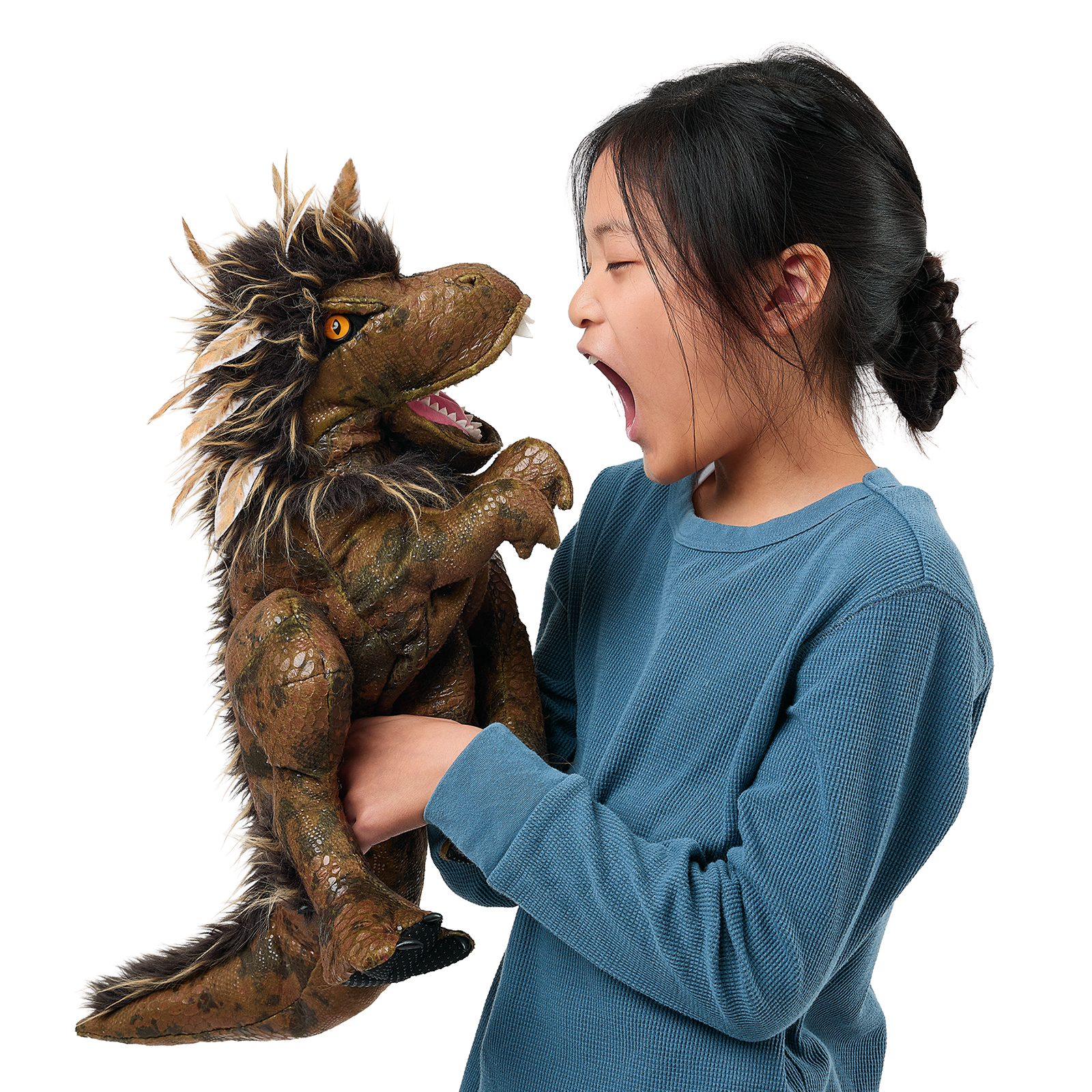 Folkmanis feathered Tyrannosaurus Rex hand puppet on a girl's arm, as she roars back at it with its mouth wide open.