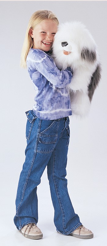 Girl in tie-dye top cuddling the fluffy white and grey Folkmanis Old English Sheepdog hand puppet.