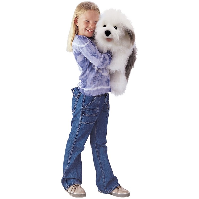 Girl in tie-dye top cuddling the fluffy white and grey Folkmanis Old English Sheepdog hand puppet.