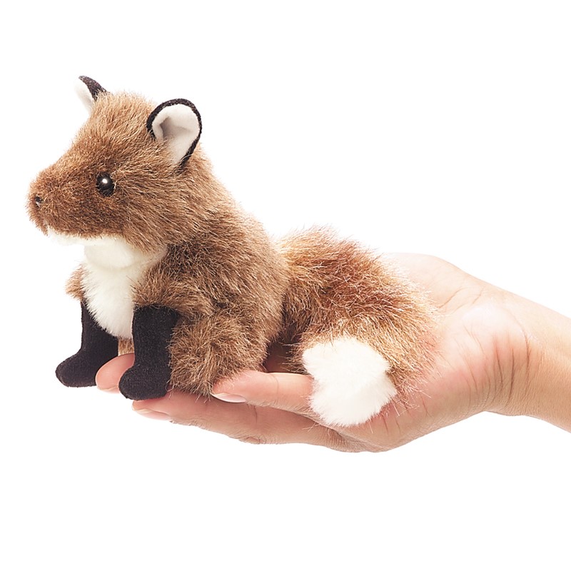 Folkmanis mini fox finger puppet in brown, white and black, seated on a palm, side view