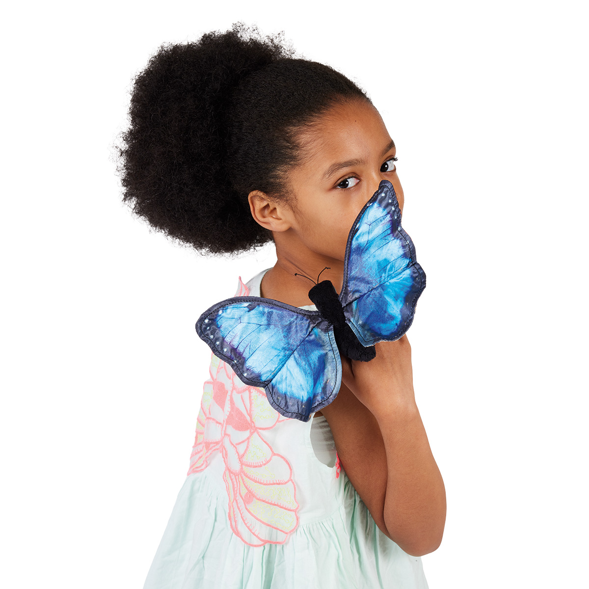 Child holding a Folkmanis blue morpho butterfly hand puppet with vivid blue fabric wings in front of their face, side view
