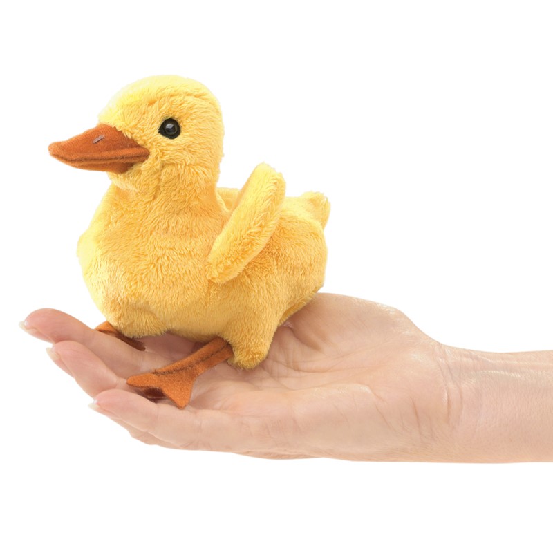 Folkmanis mini duckling finger puppet in yellow with an orange beak, sitting on a flat hand, side view