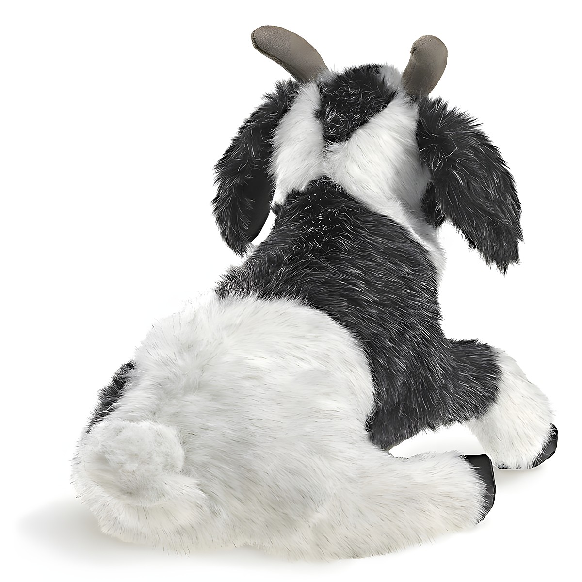 Folkmanis goat hand puppet in black and white, lying down seen from behind, with grey-brown horns and shaggy fur