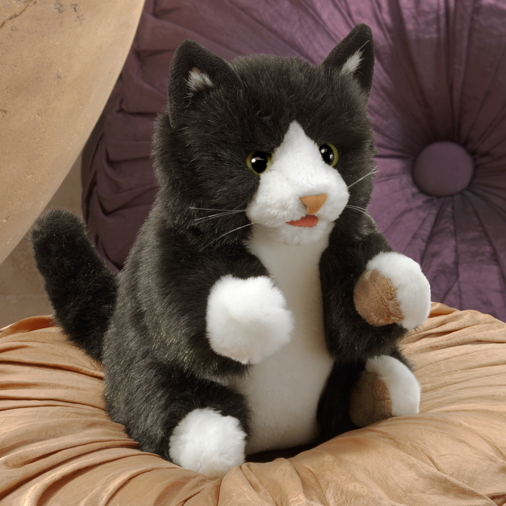 Folkmanis hand puppet tuxedo kitten in black and white, sitting with raised paws and green eyes, front view