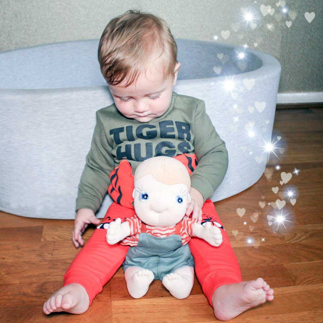 Toddler with the Rubens Tummies doll Celsius on their lap