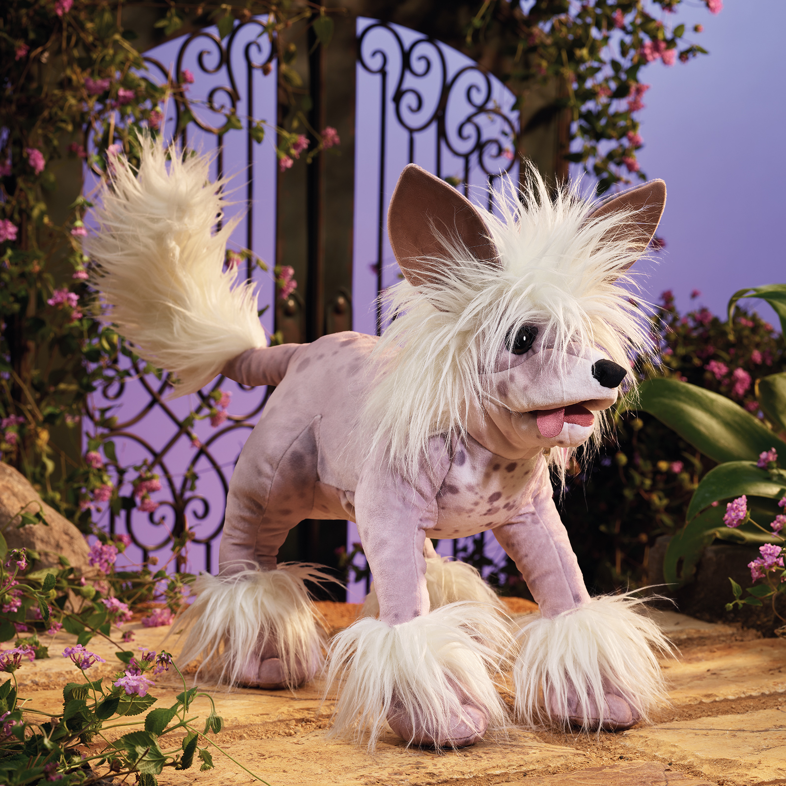 Folkmanis Chinese Crested Dog hand puppet with lilac fur, dark spots and white hair crest, side view
