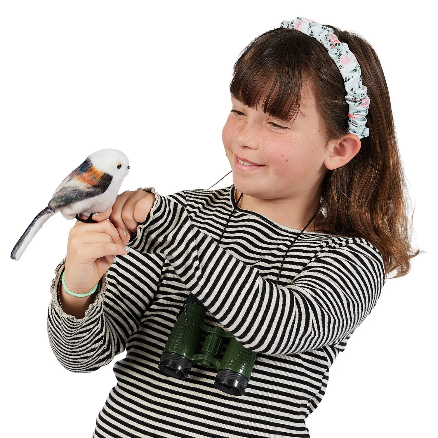 Girl holding a Folkmanis mini long-tailed tit finger puppet on her finger, with green binoculars around her neck