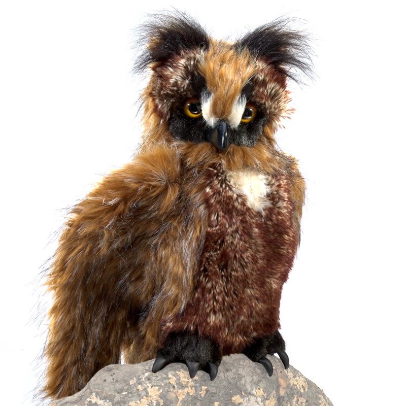 Folkmanis great horned owl hand puppet with brown-black fur, yellow eyes and feathered ears, sitting on a stone