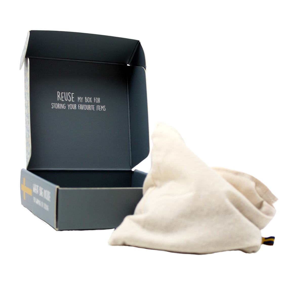 Wheat pouch warming cushion for Rubens Barn Tummies with cotton cover in front of the gift box
