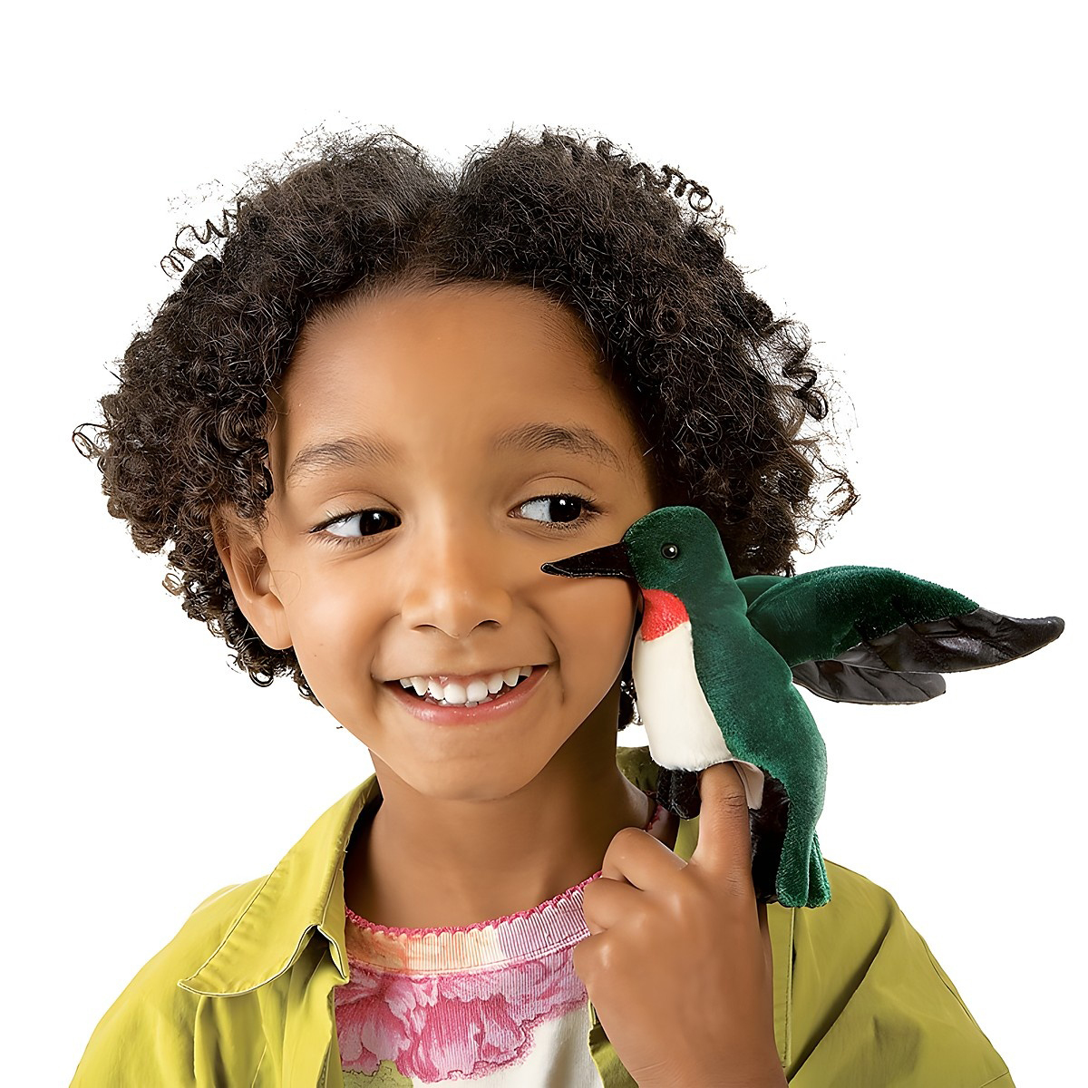 Folkmanis mini hummingbird finger puppet with green plumage and red throat on the finger of a smiling child