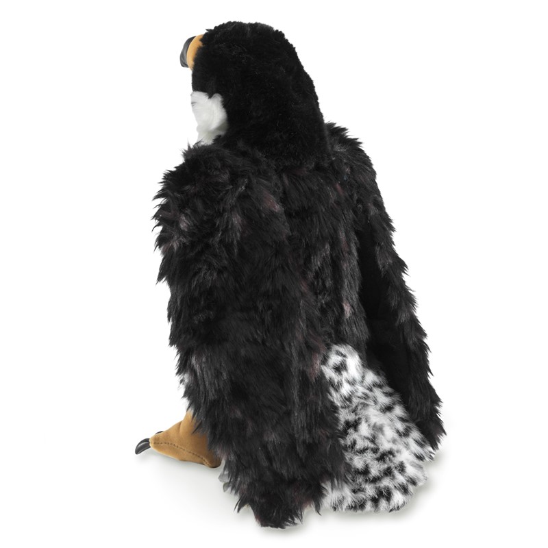 Folkmanis peregrine falcon hand puppet in side view, black plumage with black-and-white patterned belly and tan claws