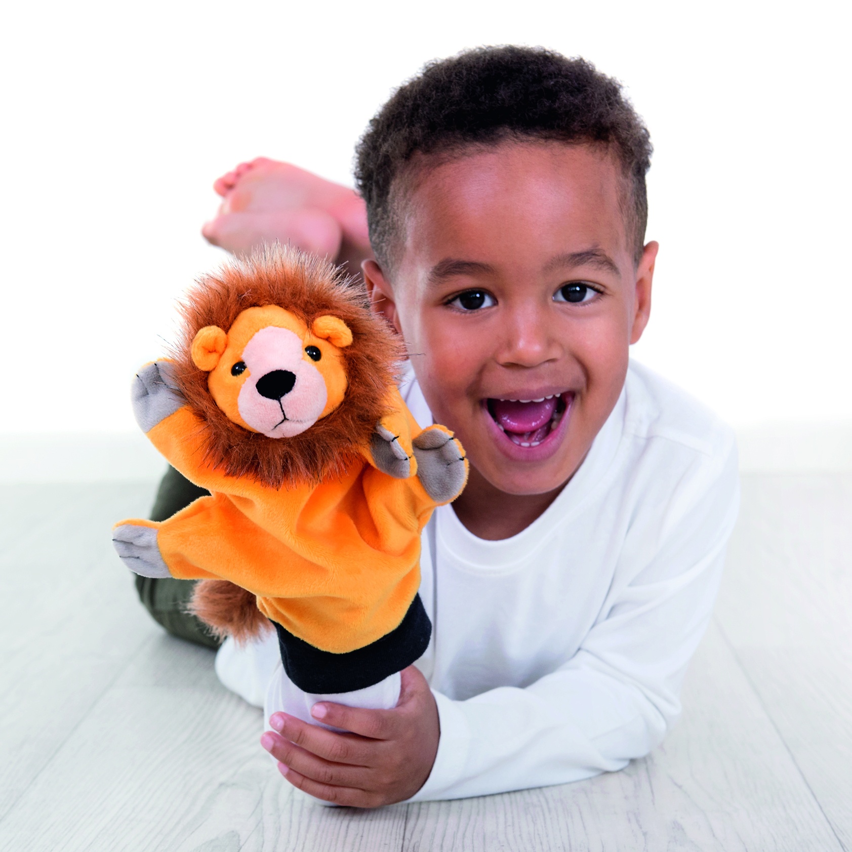 Boy laughing with the Beleduc hand puppet lion on his hand, usage example