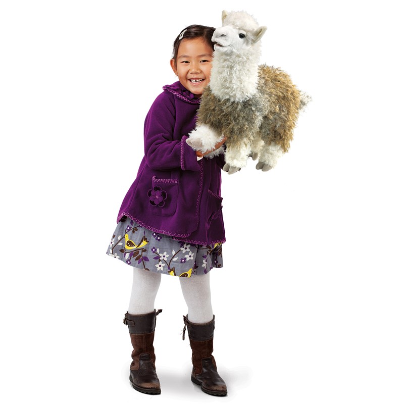 Girl holding a large Folkmanis alpaca hand puppet with a white head and beige body in her arms