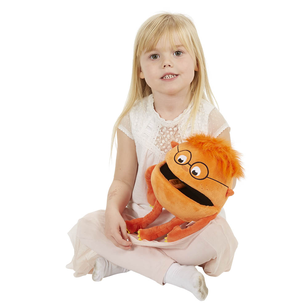 Girl holding the The Puppet Company orange baby monster hand puppet on her lap, usage example