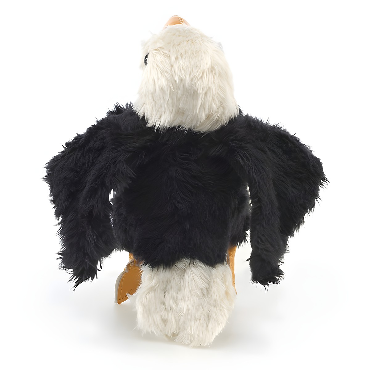Folkmanis mini bald eagle finger puppet seen from behind, with black plumage, spread wings, and a white head