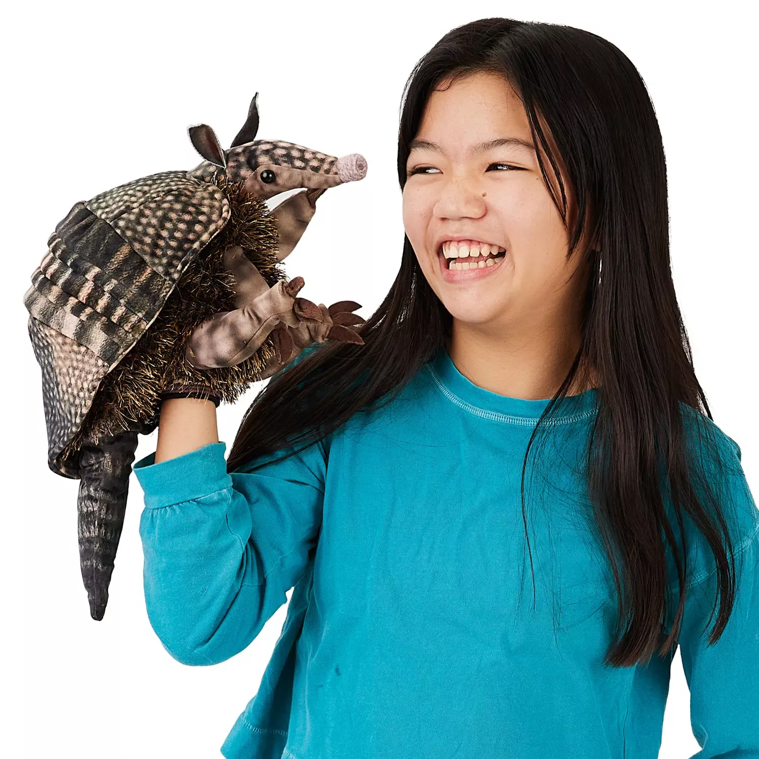 Girl wearing the Folkmanis armadillo hand puppet with detailed shell and trunk-like snout on her right hand